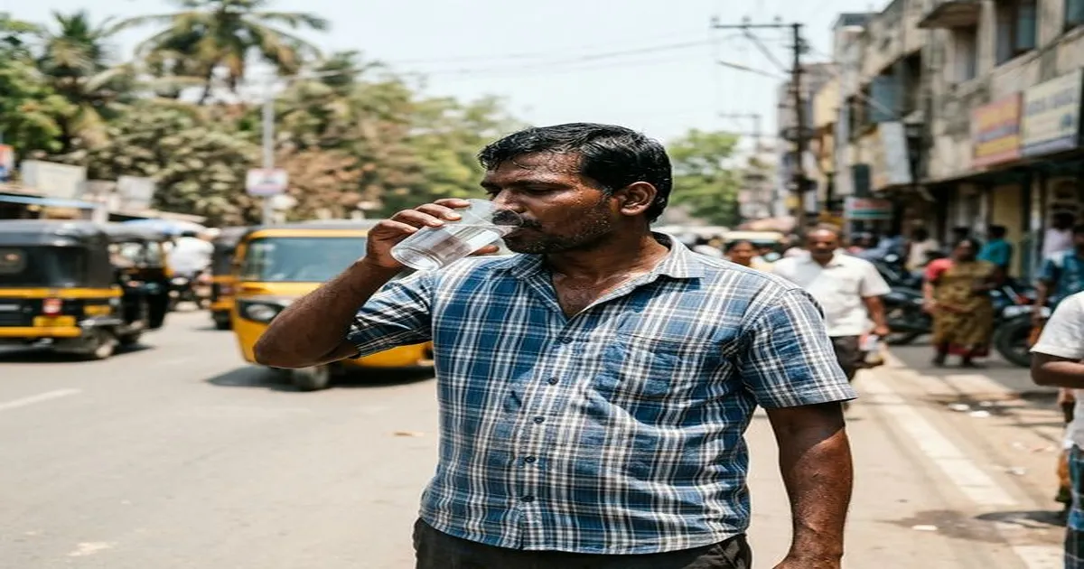 Person drinking water in Chennai summer heat to maintain oral health and saliva production